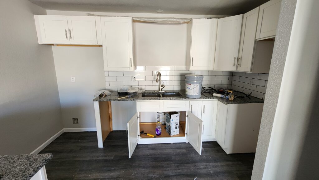 Kitchen installation showcasing custom cabinetry and appliance placement