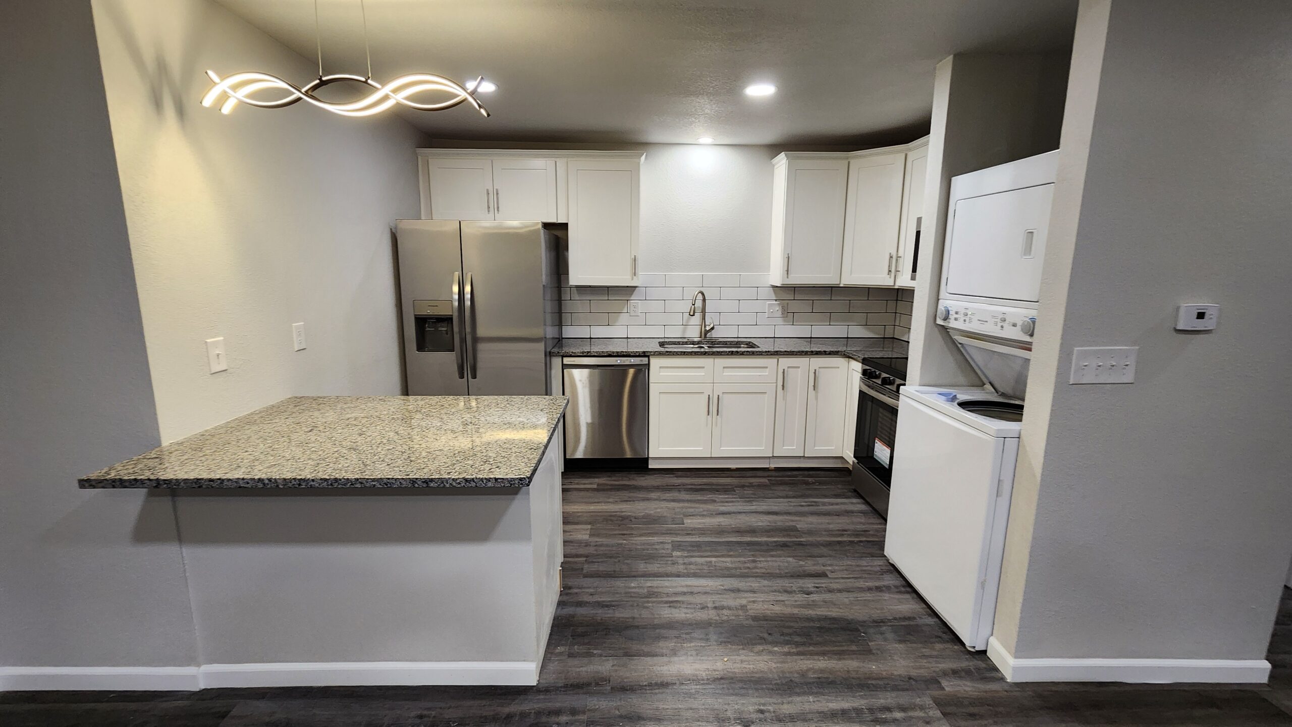 Full kitchen remodel with dark cabinetry and premium fixtures by AKK Platinum Installations